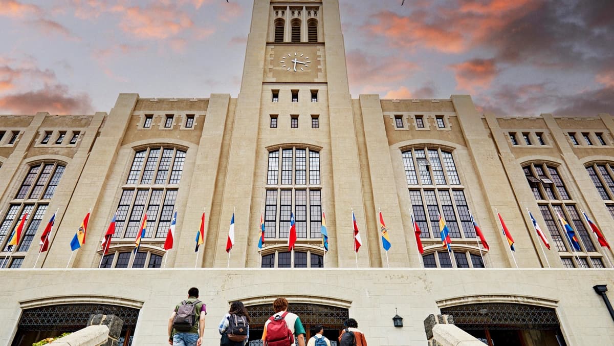 students walking up to campus building