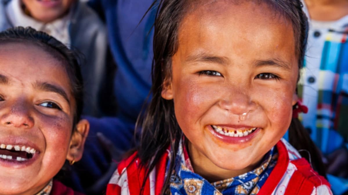 Kids smiling and laughing looking at the camera 