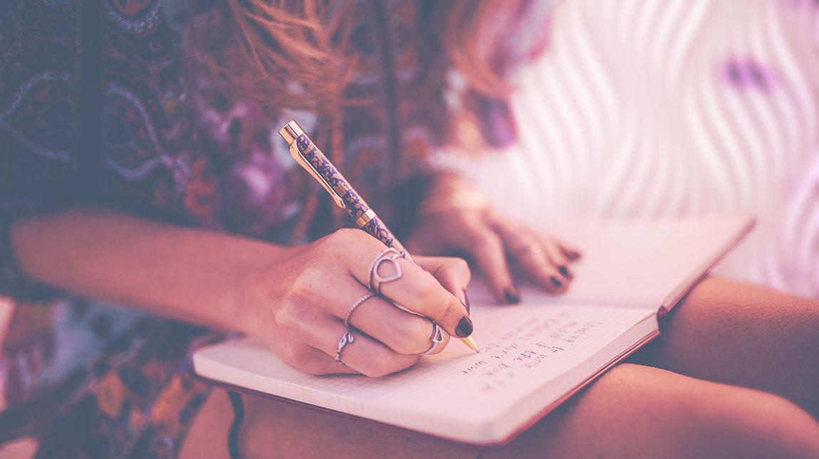 close up of girl writing in her journal